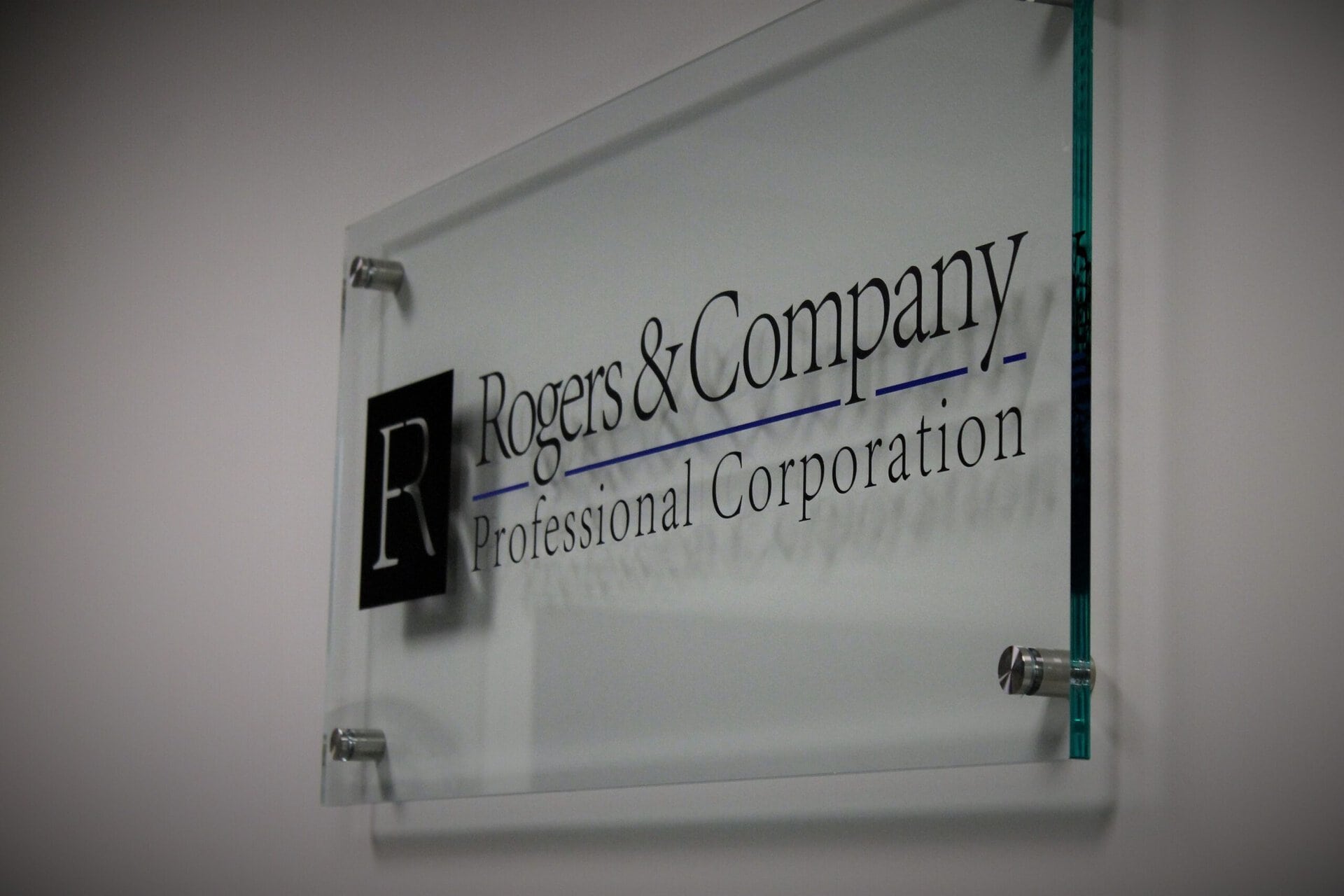 Rogers & Company professional corporation sign on office wall.