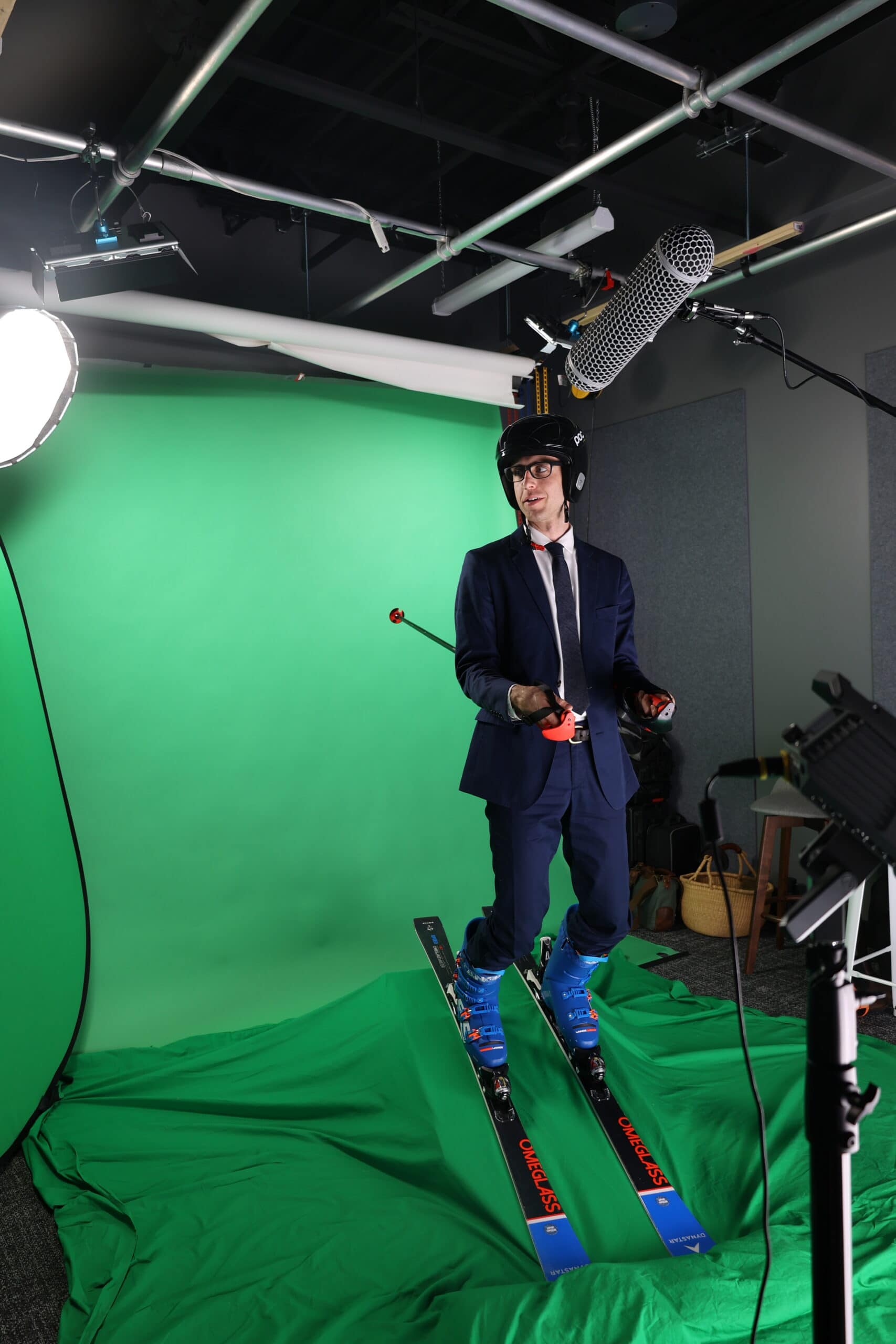 Person in a suit skiing on a green screen background.