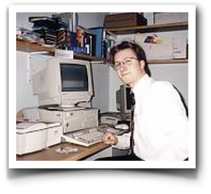 Old computer workstation with market technology focus, featuring a person in office setting.