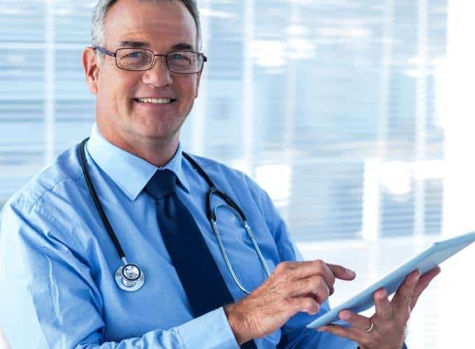 Portrait of male doctor with digital tablet in hospital