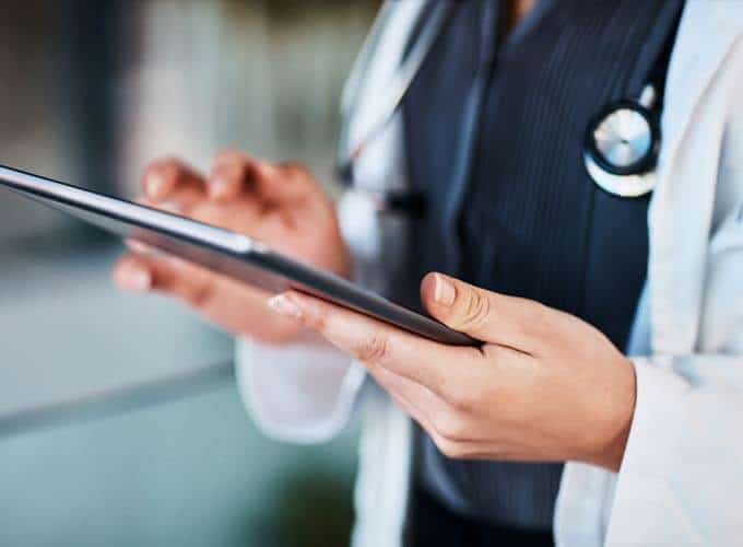 doctor and tablet in hands at hospital