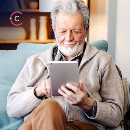 Senior man using digital tablet at home