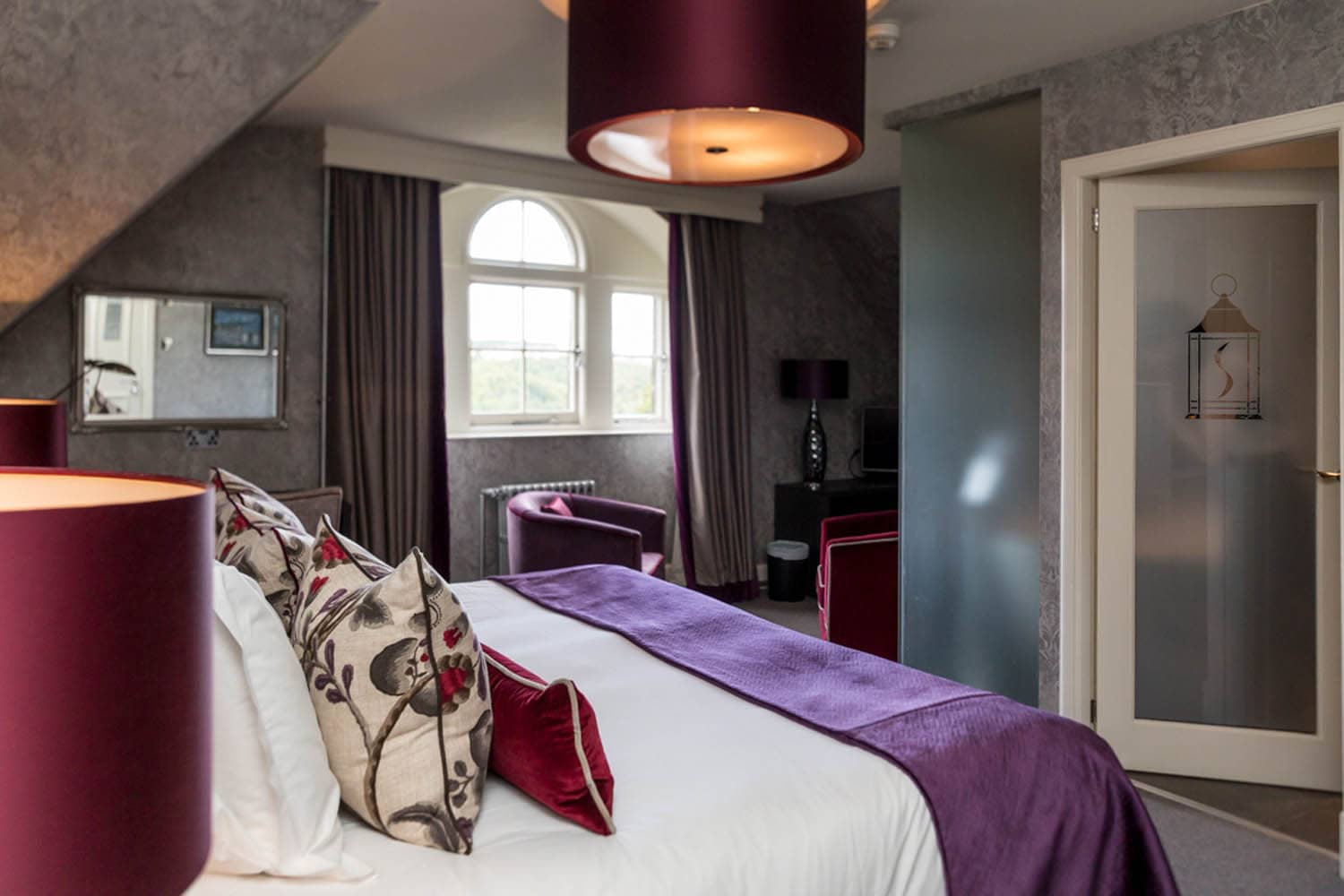 Elegant hotel room at The Dowans Hotel with stylish decor and cozy furnishings.