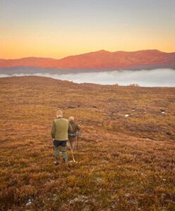 Tranquil sunset over Erchless Castle Estate with hikers exploring the Highland landscape.