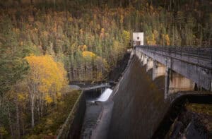 Scenic view of Erchless Castle Estate dam and autumn forest landscape in autumn.