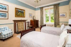 Lavish bedroom at Erchless Castle Estate with period furnishings and scenic views.