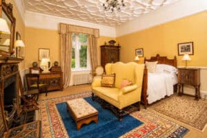 Elegant interior of Erchless Castle Estate with antique furnishings and classic decor.