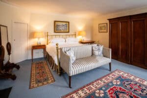 Elegant bedroom at Erchless Castle Estate with antique furnishings and traditional décor.