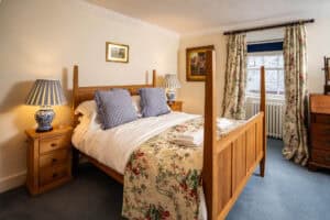 Charming bedroom at Erchless Castle Estate, featuring classic Scottish interior decor and elegant furnishings.