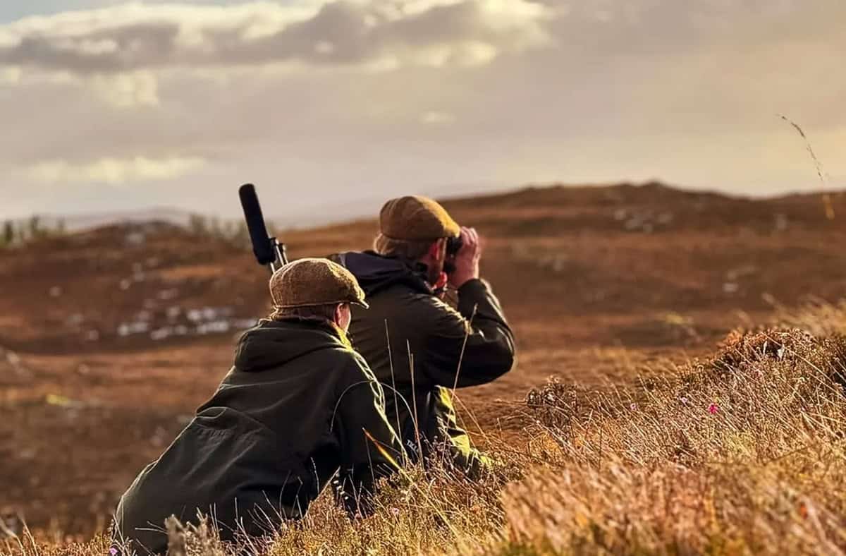 Birdwatchers enjoying scenic views at Erchless Castle Estate, Highland outdoor hunting and nature experience.