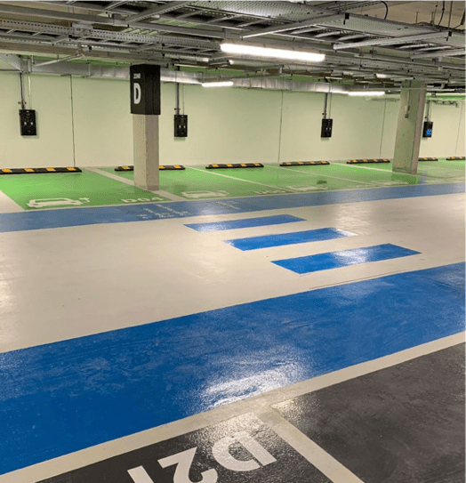 Charging station floor markings with designated parking bays for electric vehicles.
