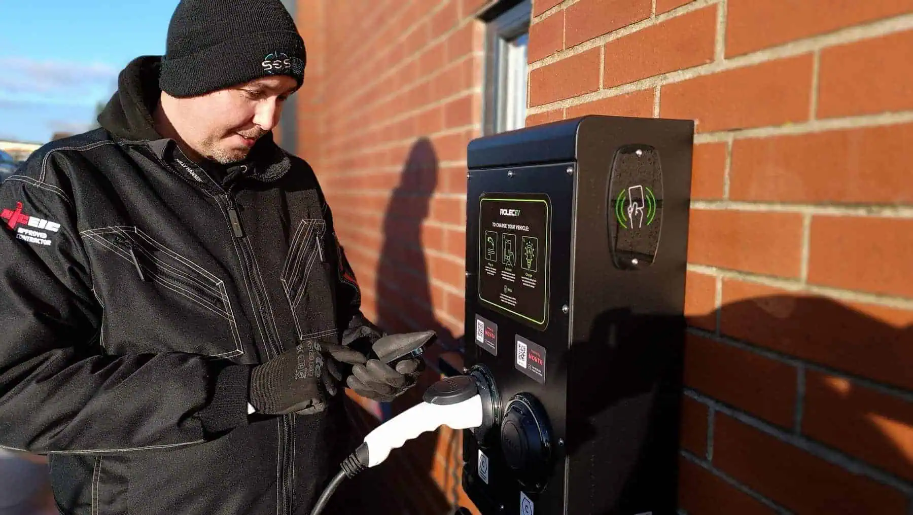 Electric vehicle charging point being installed outdoors at a residential property.
