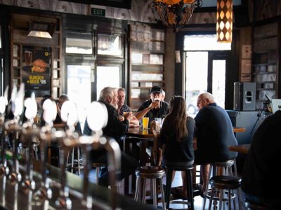 Interior view of Frederic's Restaurant & Bar with patrons enjoying drinks and conversation.
