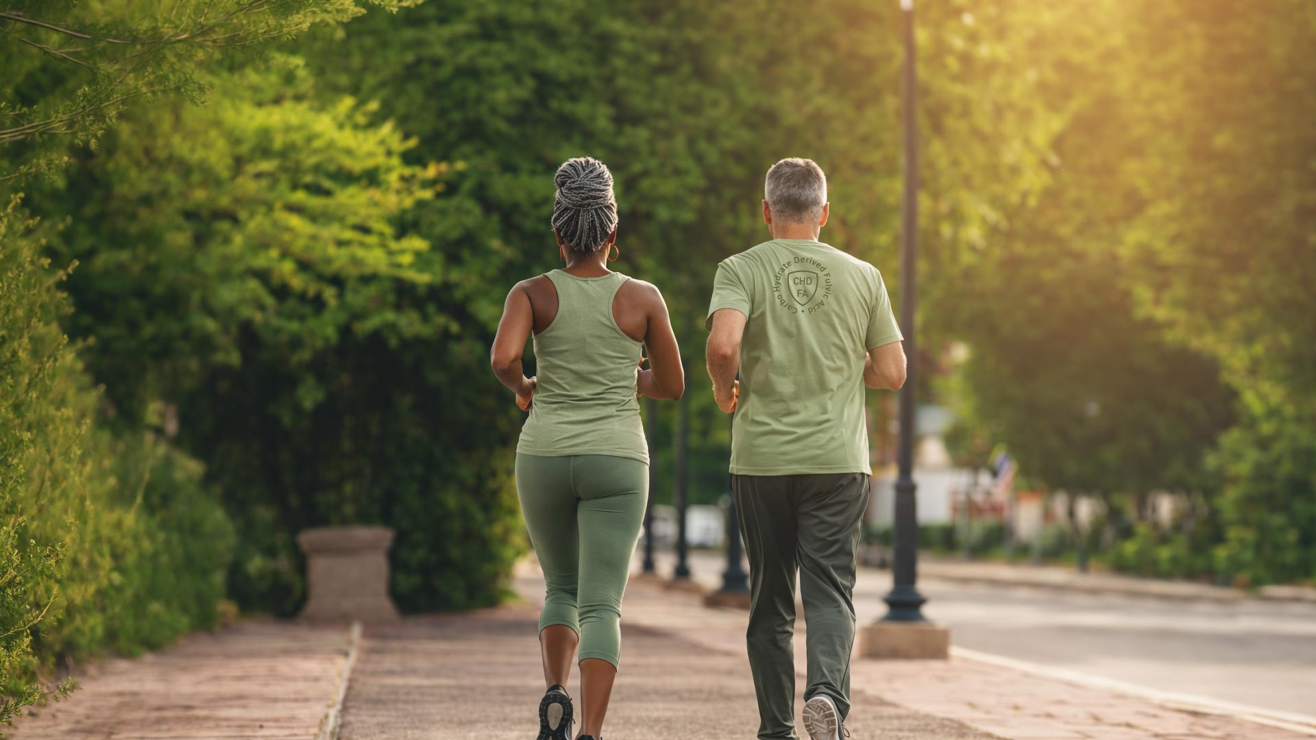 Two people walking in a park during sunset, promoting health and wellness.