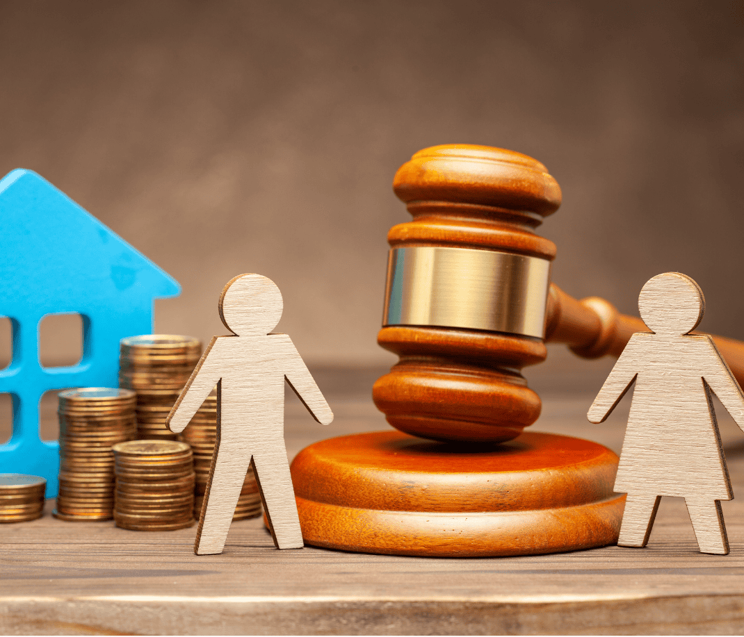 Financial dispute resolution concept with wooden figurines, gavel, coins, and a house model.