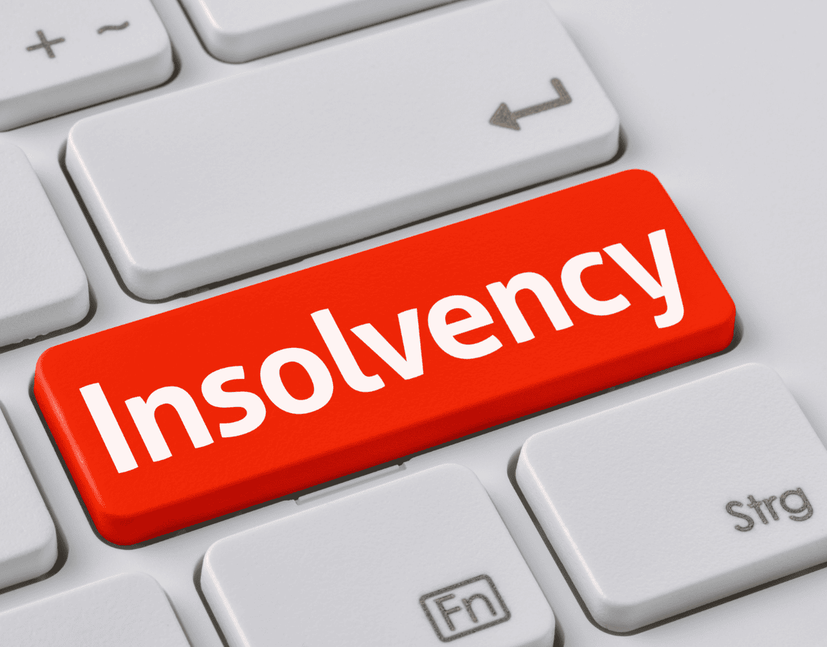 Close-up of a red "Insolvency" button on a white computer keyboard, symbolising financial crisis or business insolvency issues.