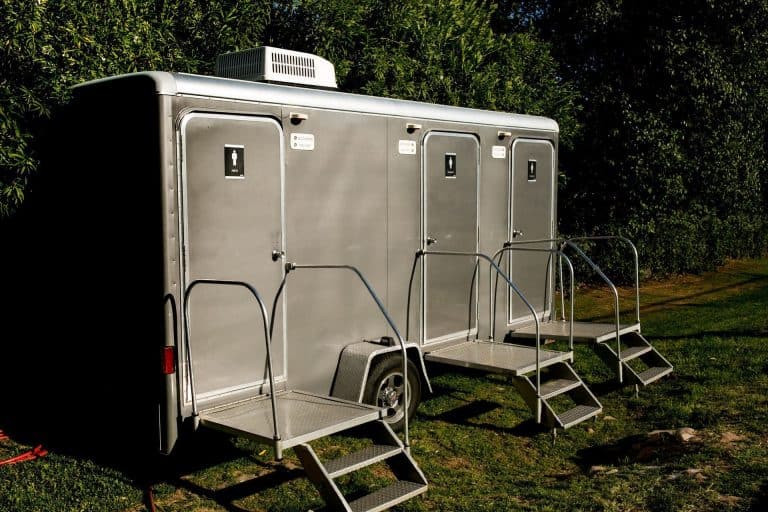 Modern luxury restroom trailer with multiple units and steps for easy access.