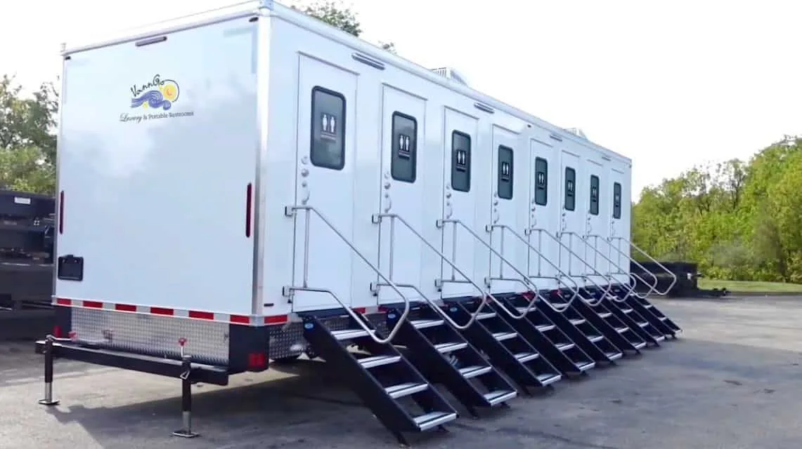 VannGo eight-station commercial restroom trailer with a row of stall doors and steps
