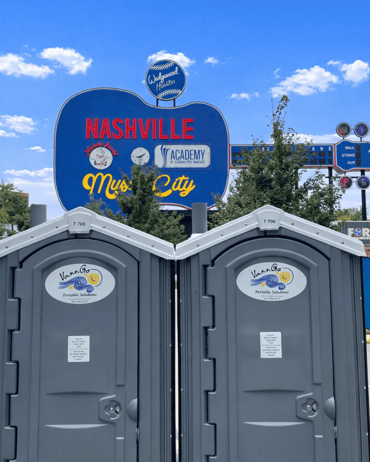 Two VannGo portable toilets set up in front of the Nashville sign