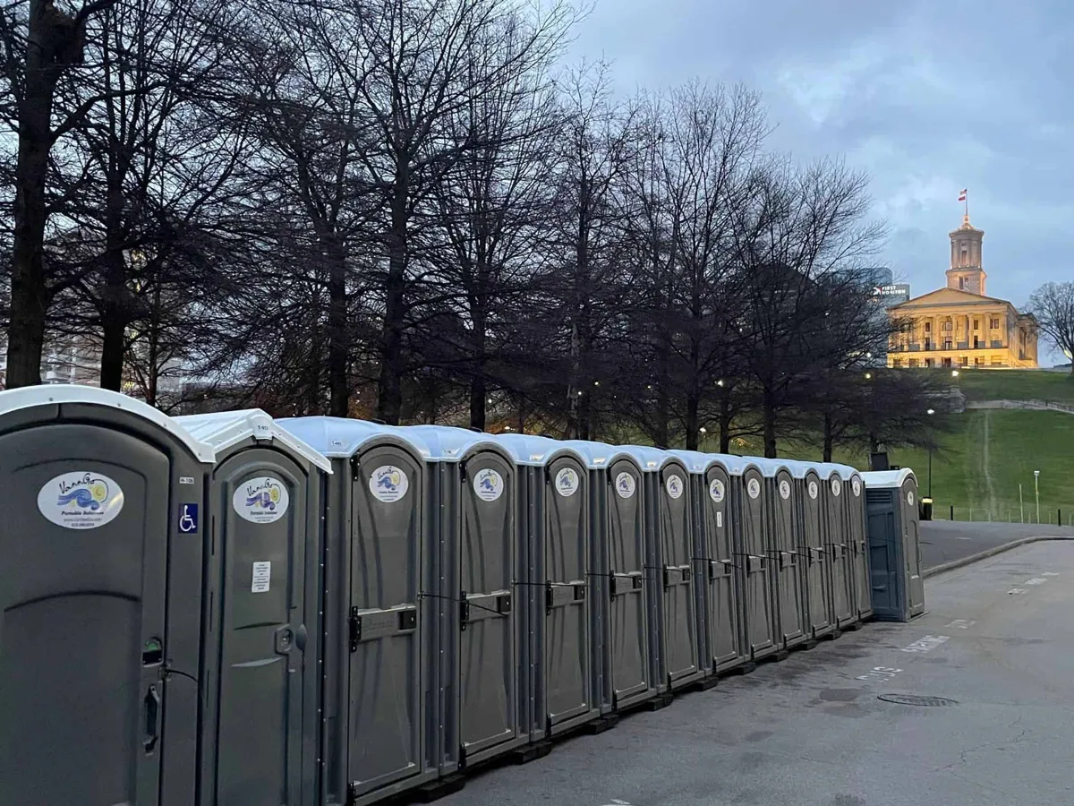 Row of VannGo portable restrooms staged near a historic-district job site, for rent in Franklin, TN