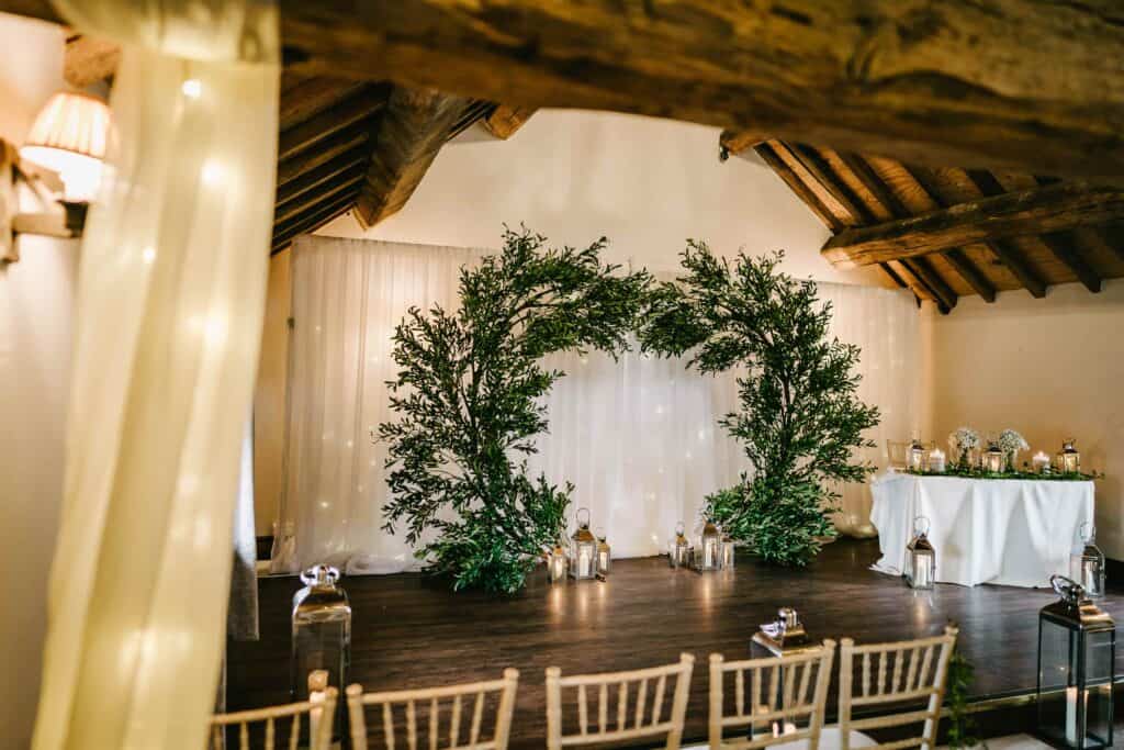 Wedding ceremony setup at Hyde Bank Farm with rustic decor and greenery.
