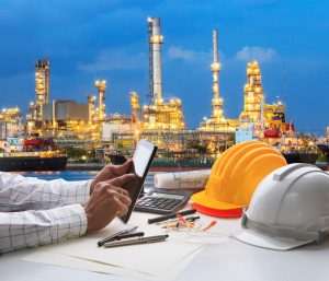 &nbsp;>thisisjustarandomplaceholder<engineering working on computer tablet  against beautiful oil refinery background | Iberian Press®&nbsp;