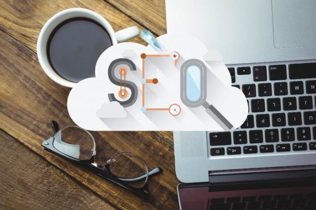 Cloud-themed infographic for SEO over a desk with a coffee mug, glasses, and a laptop keyboard, symbolizing cloud-based optimization work