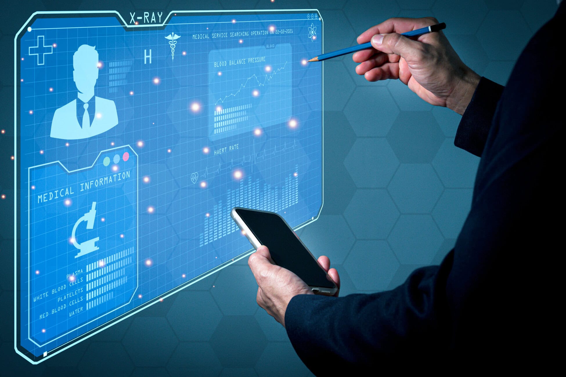 Hands interact with a blue holographic medical dashboard while holding a smartphone nearby on a dark suit sleeve
