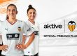 Three Valencia CF Femenino players pose in white jerseys with sponsor logos visible (TM Real Estate) and the Active branding on the right side of the image.