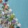 Colorful jigsaw pieces scattered across a surface beside a mostly completed blue puzzle center-right.