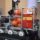 Robotic platform carrying orange balls inside a clear frame, with ESP Spain labels and Spanish flags on the side.