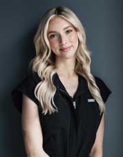 Olivia - Smiling blonde woman in black sleeveless top