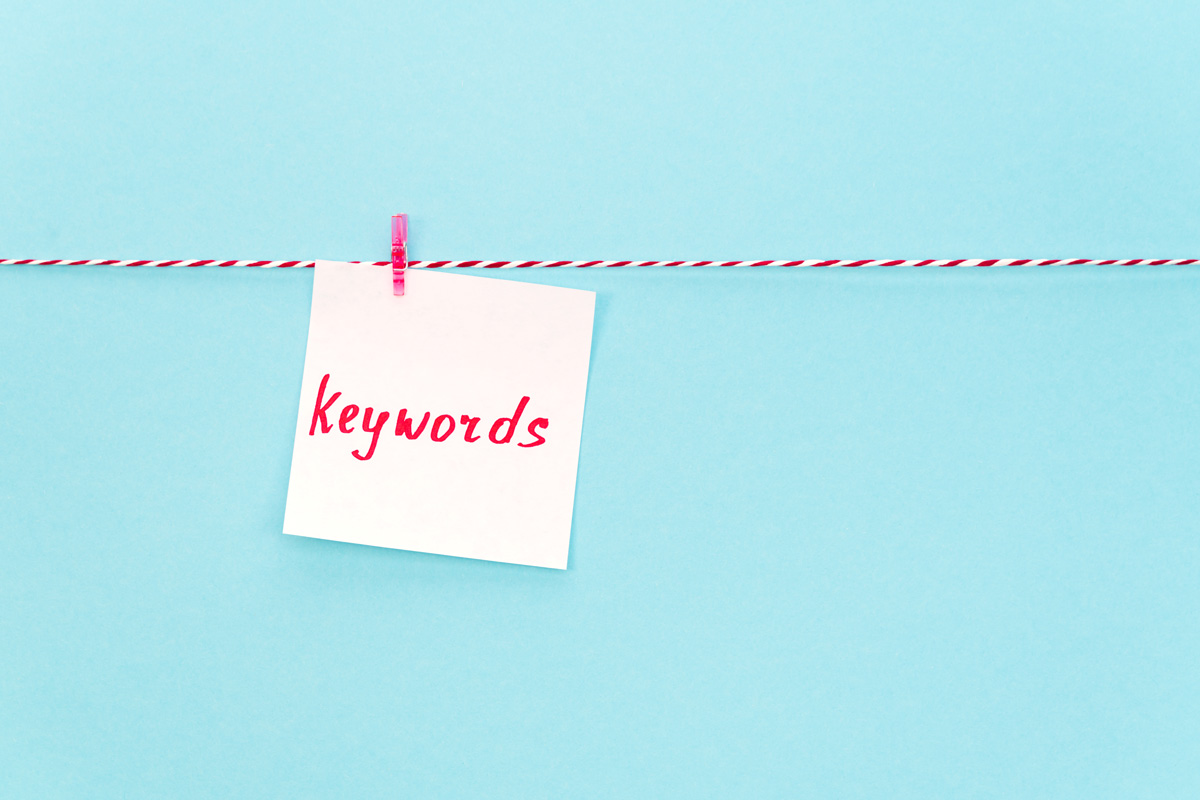 Keyword stuffing. A red and white string with a close pin holding a note that says keywords.