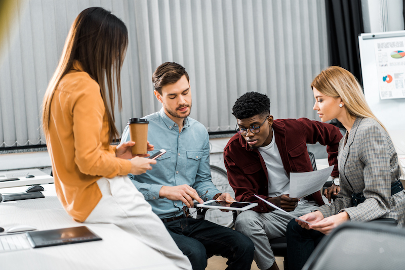 Multicultural Young Businesspeople Discussing New Business Idea In Office