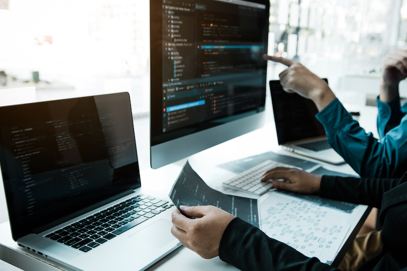 Two People Team Working Development Of Programming And Encryption Technology Website Design Programmers On Desk In Office.