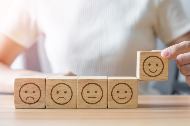 Hand Choosing Smile Face From Emotion Block. Customer Review, Good Experience, Positive Feedback, Satisfaction, Survey, Rating Service, Assessment, Mood, World Mental Health Day Concept
