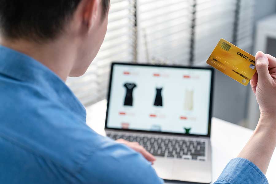 Man Using Laptop With Credit Card