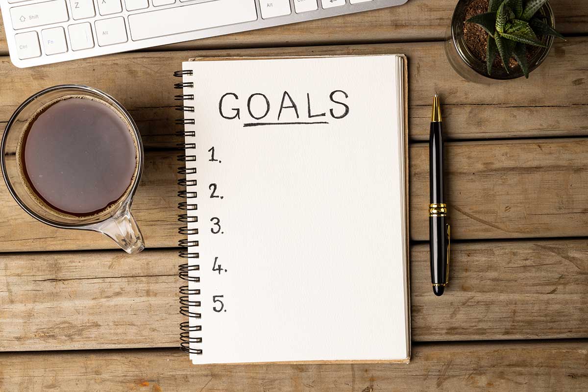 Notebook With Goals Written On Paper