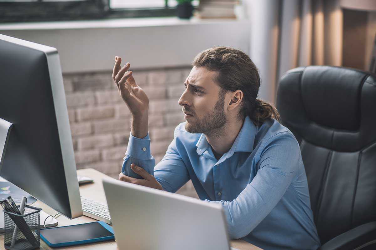 Confused Man Looking At Computer Screen