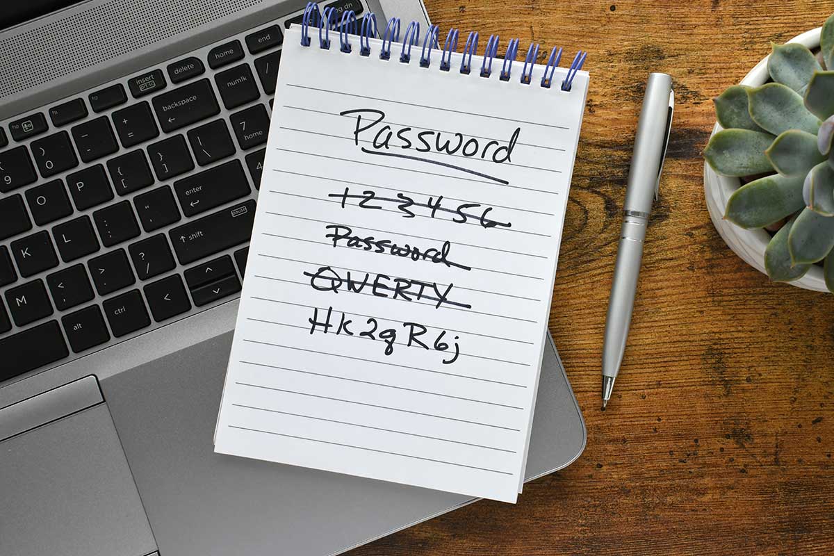 Password List On Notebook Laying On Keyboard
