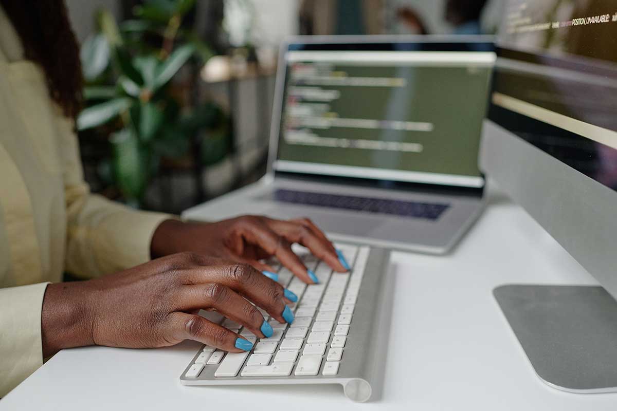 Manicured Hands Typing On Keyboard