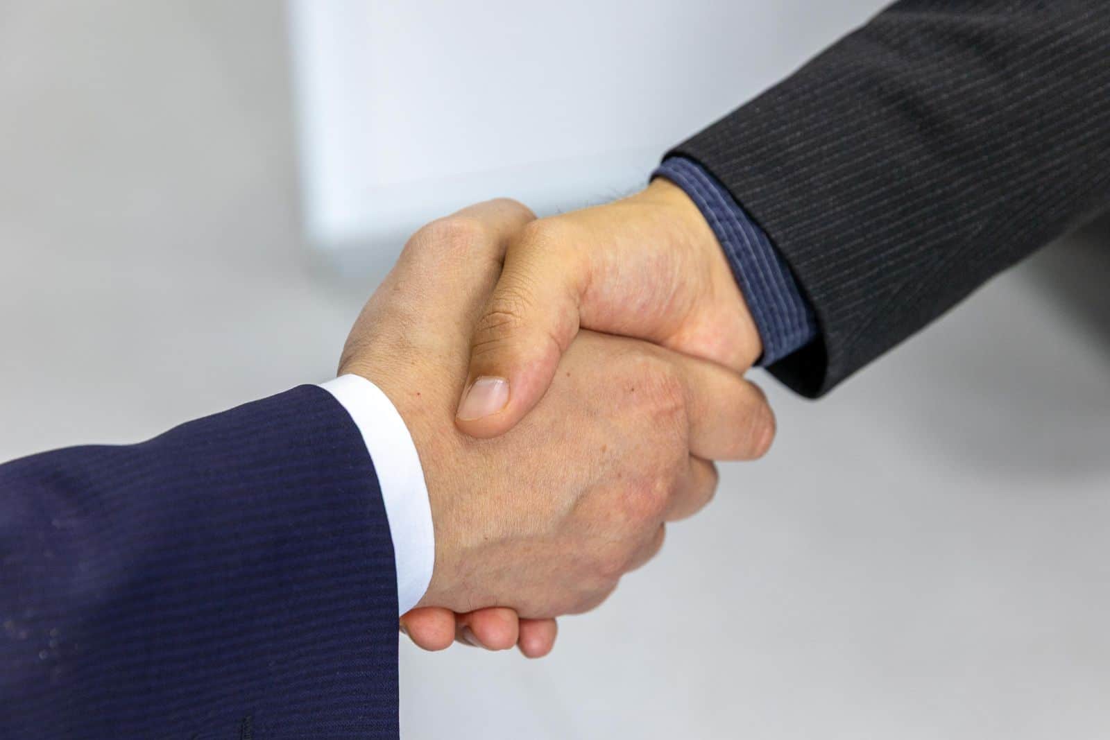 Professional handshake welcoming a new rental property owner