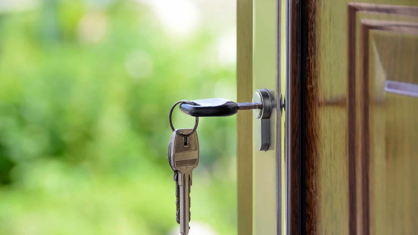 Metal key inserted into the deadbolt lock of a Las Vegas rental home front door