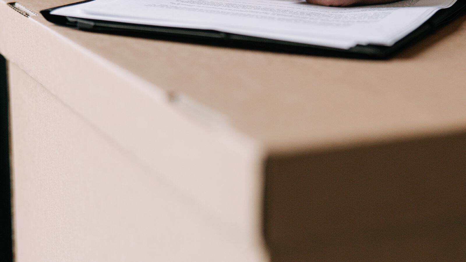 Hands signing a Nevada residential lease agreement in a Las Vegas apartment