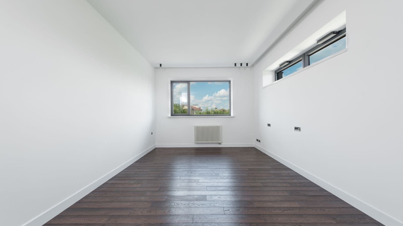 Empty room in a modern Las Vegas apartment after a tenant moved out, wide interior view of bare walls and floor