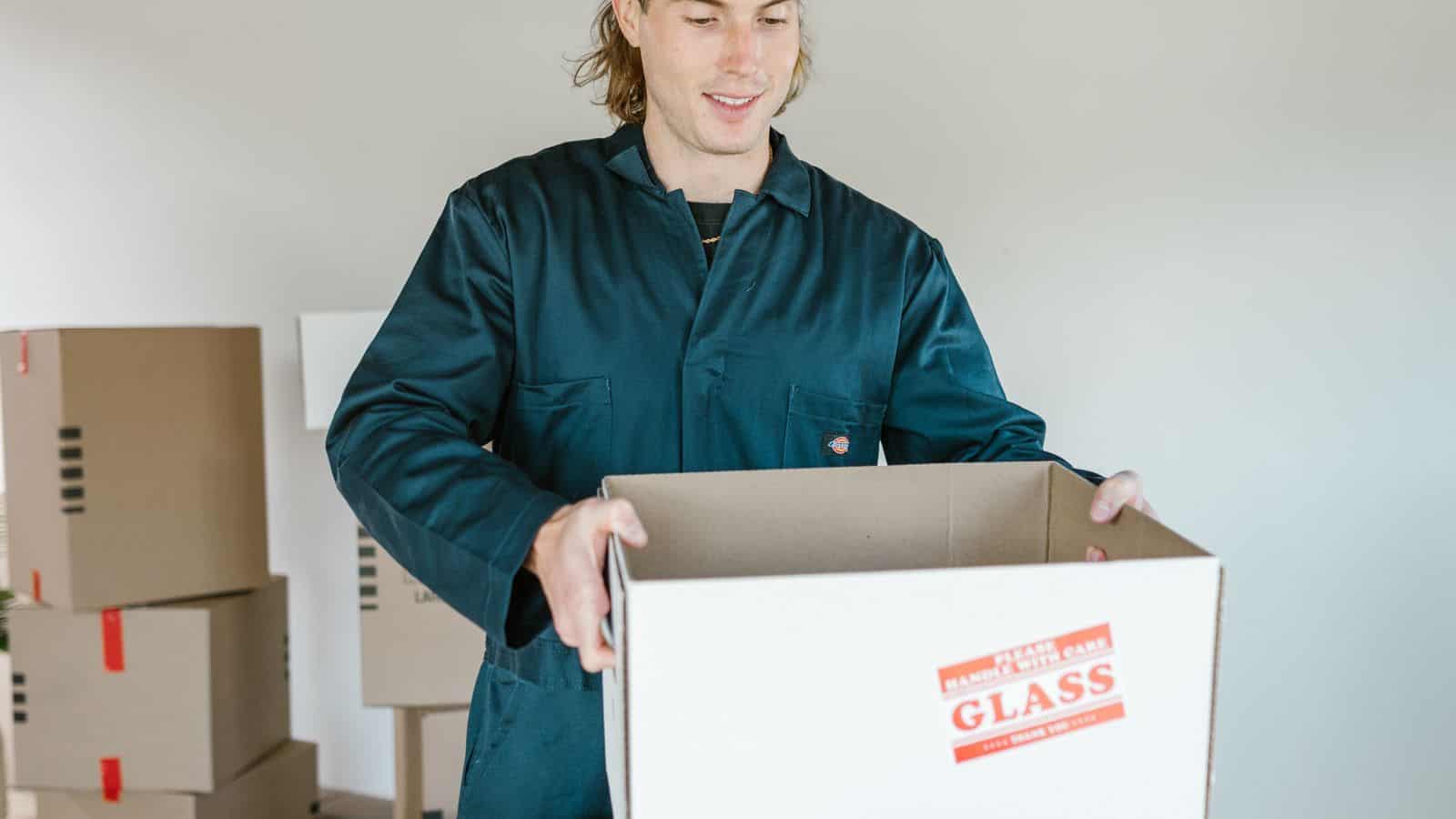 Woman carrying a moving box marked fragile