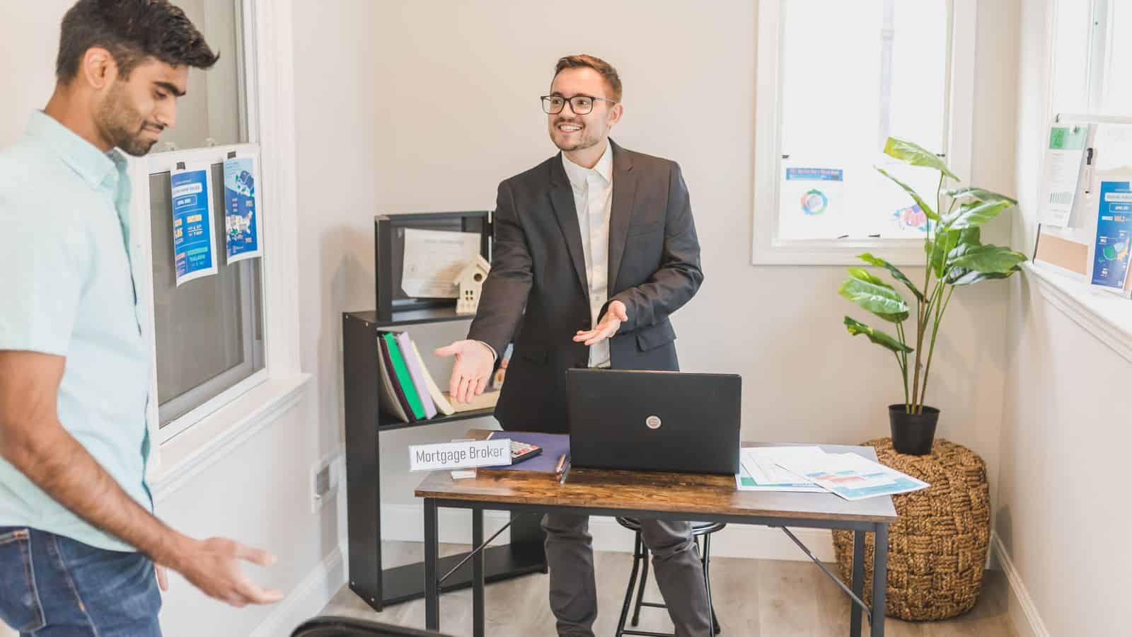 Property manager and client discussing options at a small local real estate office desk in Las Vegas