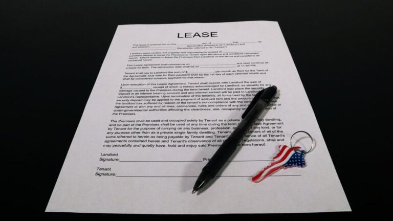 A renewal lease document and a pen on a kitchen counter in a Las Vegas home with autumn light through the window, no peo