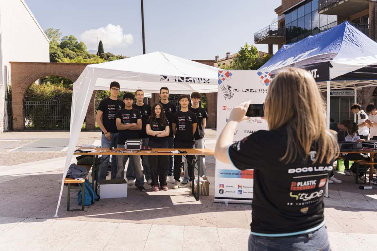 A group of people standing around a tent