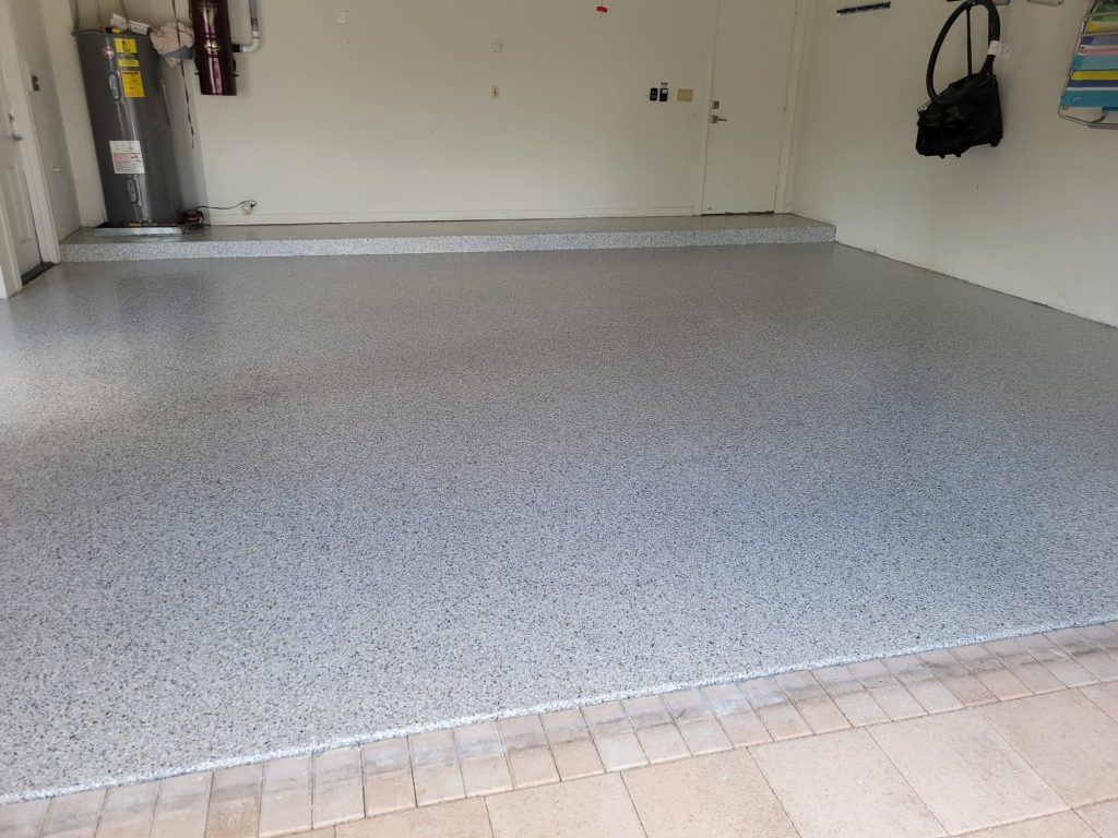 garage-floor-coating-palm-beach-county-jc-elite Polyaspartic flooring: gray flake epoxy garage floor with a protective topcoat